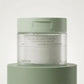 Commercial product photography of Celimax Ji Woo Gae Cica BHA Blemish Toner Pad jar, placed on a matte sage green pedestal. Clean minimalist background, soft professional studio lighting, crisp details, hyper-realistic texture, no CGI. Shot on 70mm lens, F7, ISO 250, photorealistic --ar 1:1 (gemini-3-pro-image-preview)